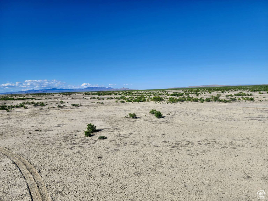 Water view featuring a desert landscape, a mountainous background, and rural landscape