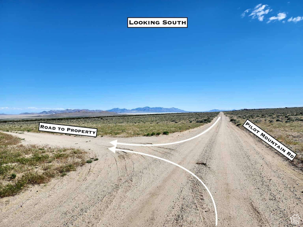 View of dirt / gravel road with a mountain view