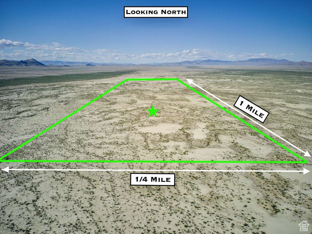 Aerial view of sparsely populated area with mountains, a desert landscape, and property boundaries highlighted