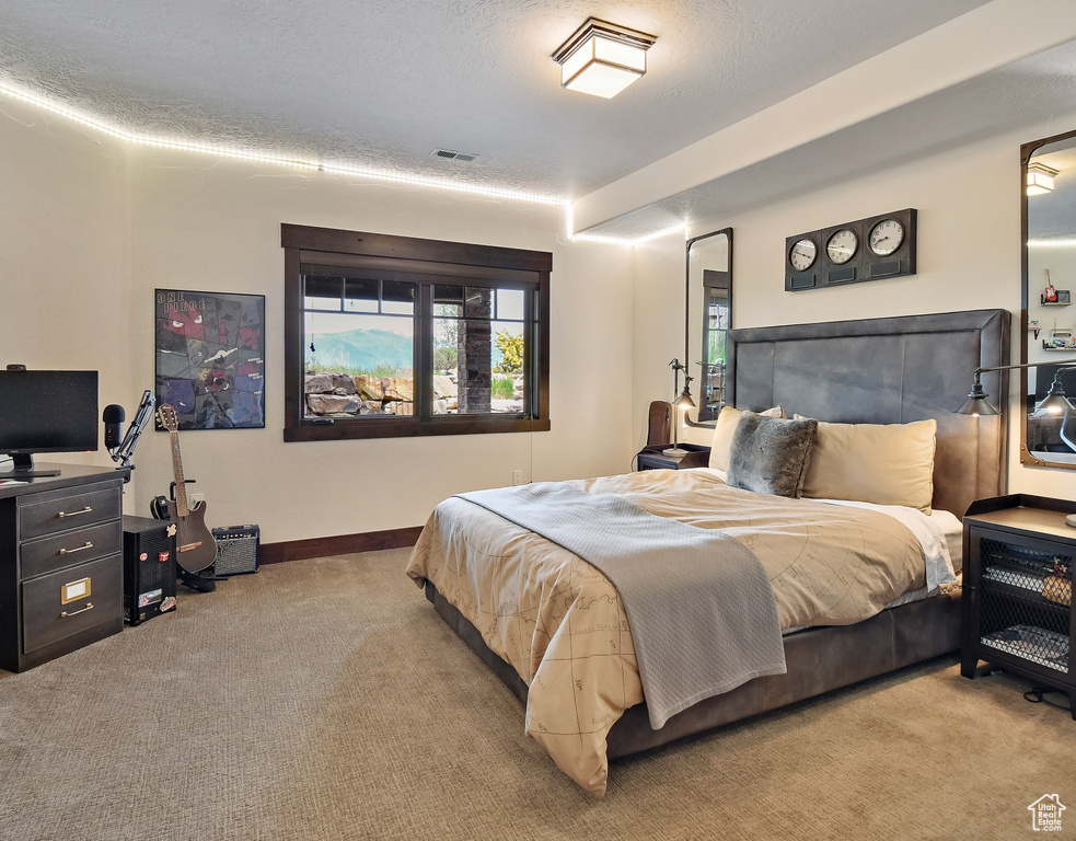 Carpeted bedroom featuring baseboards