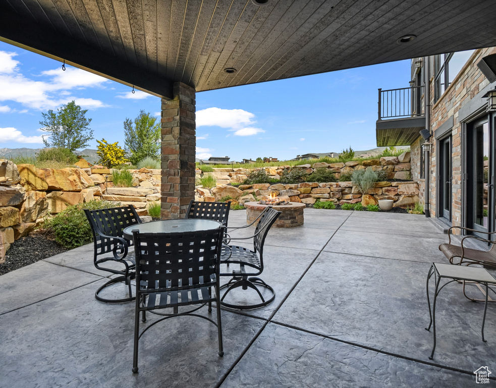 View of patio featuring an outdoor fire pit and outdoor dining space