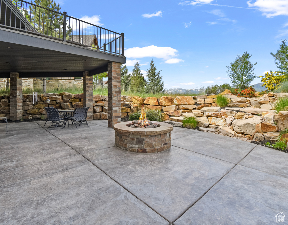 View of patio / terrace with a fire pit and outdoor dining space