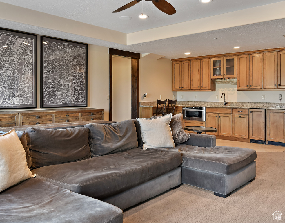 Living room with a ceiling fan and recessed lighting