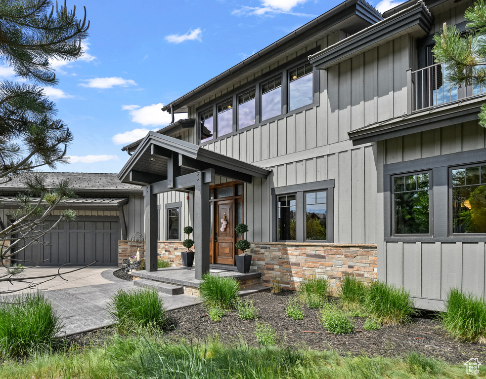 View of front of home with board and batten siding and stone siding