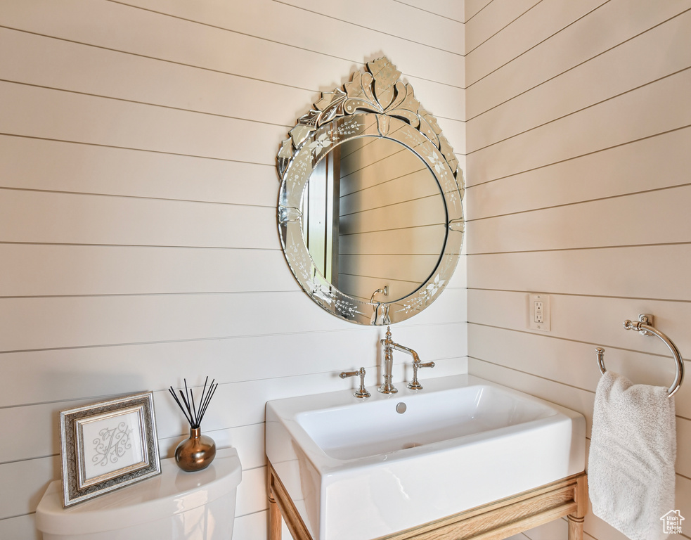 Bathroom with wood walls and vanity