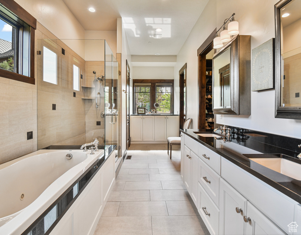 Bathroom with a stall shower, double vanity, a whirlpool tub, tile patterned flooring, and recessed lighting