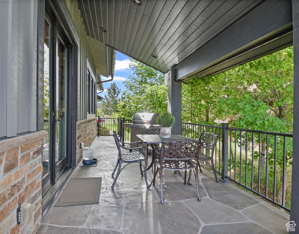 View of patio featuring outdoor dining area and area for grilling