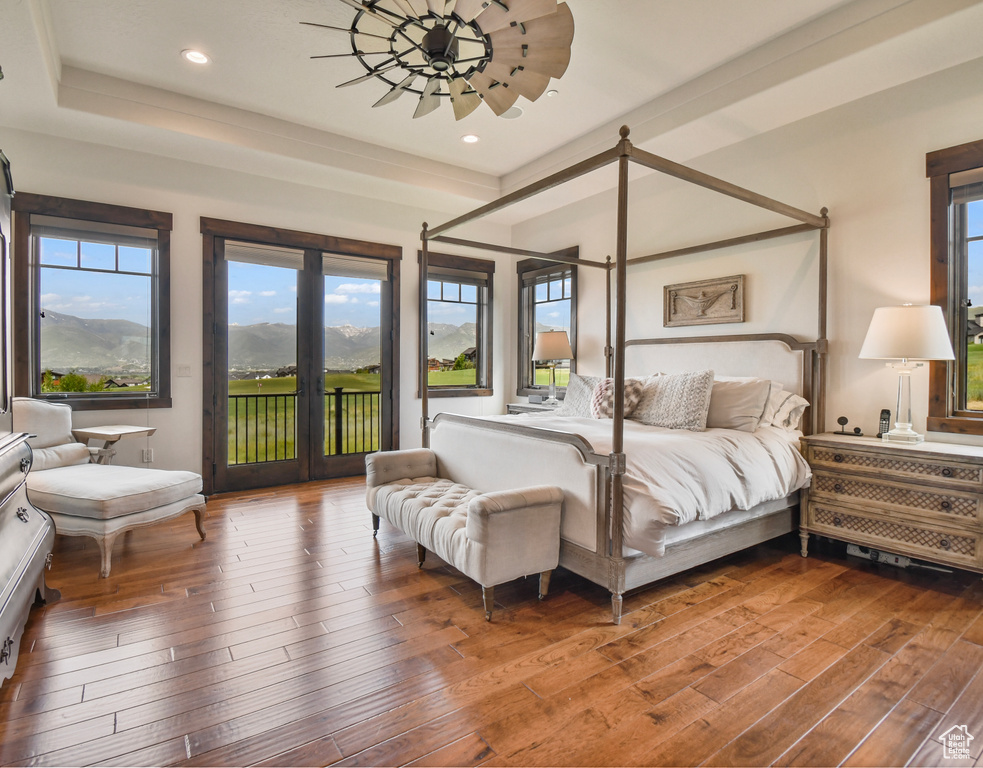 Bedroom featuring access to exterior, wood-type flooring, and recessed lighting