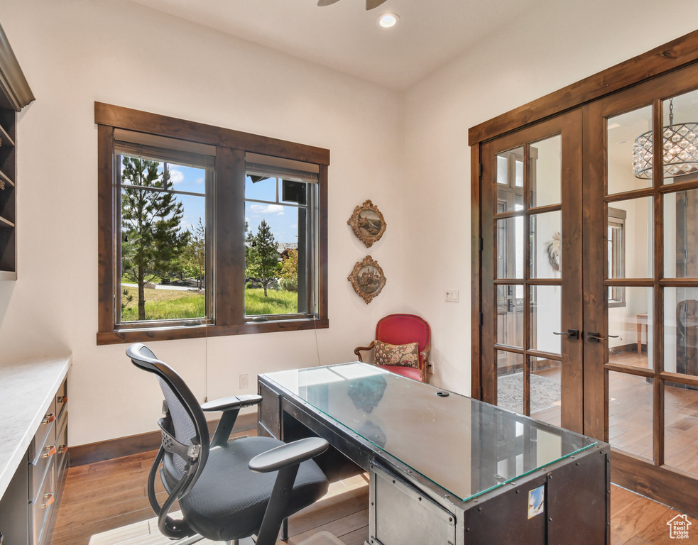 Home office with french doors, light wood-style floors, recessed lighting, and baseboards