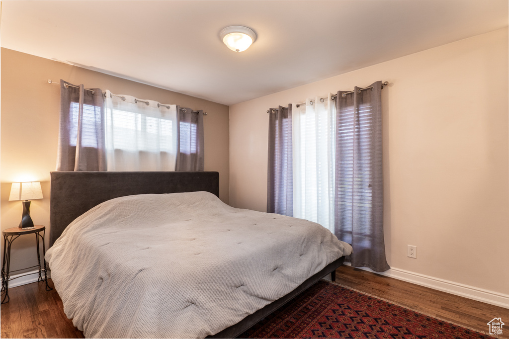 Bedroom featuring wood finished floors and baseboards