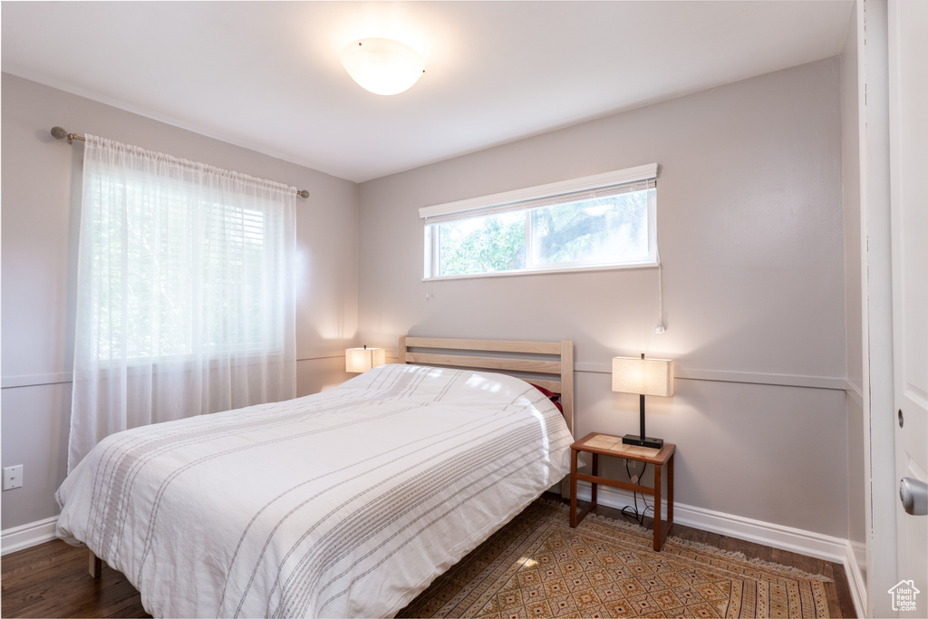 Bedroom featuring baseboards and wood finished floors