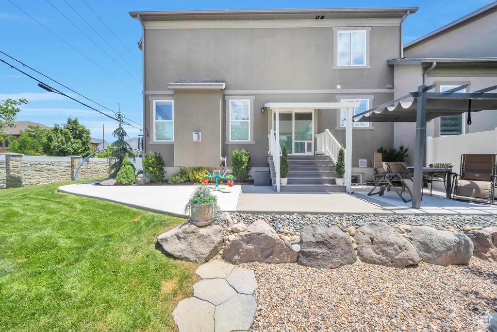 Back of house featuring stucco siding and a patio