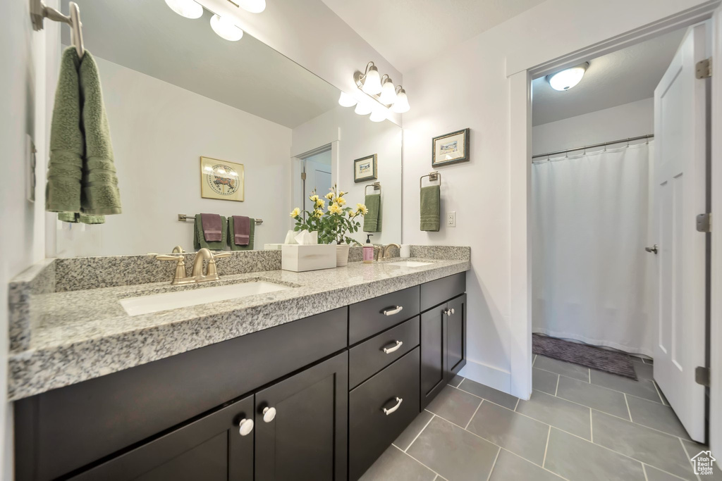 Bathroom featuring double vanity and tile patterned flooring