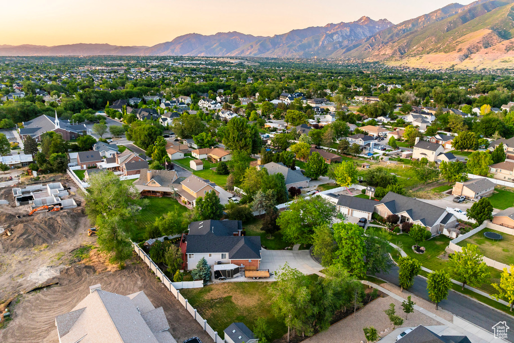 Aerial view of property's location with a mountain backdrop and nearby suburban area