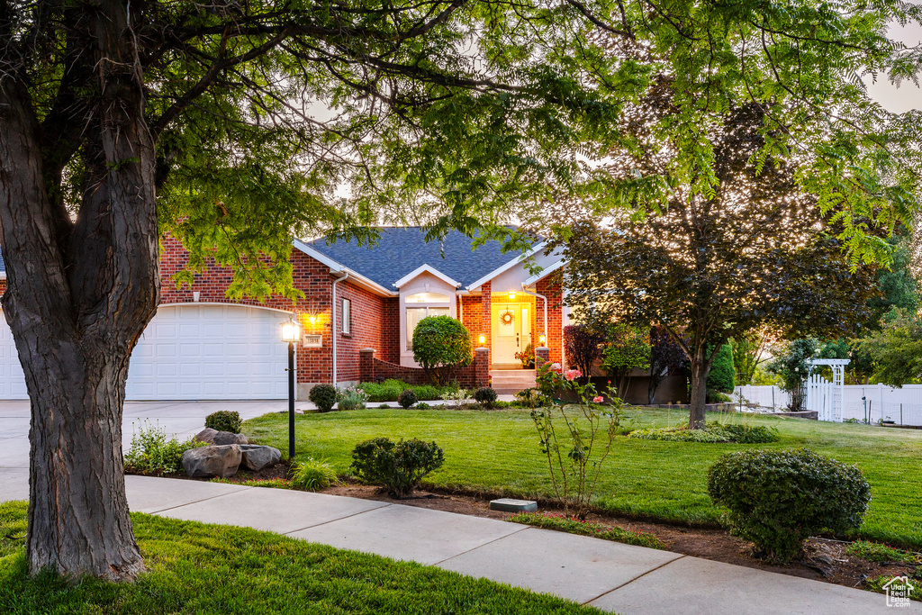 View of front of home featuring brick siding, a garage, concrete driveway, and roof with shingles