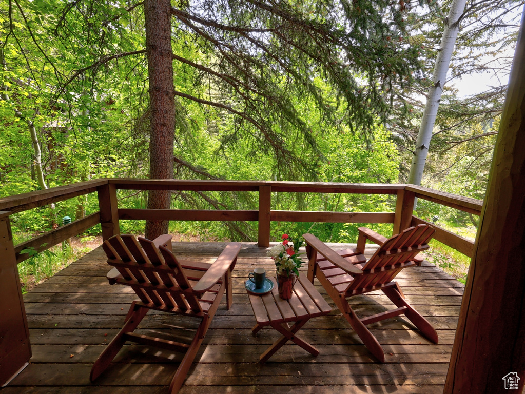 Wooden deck featuring a wooded view
