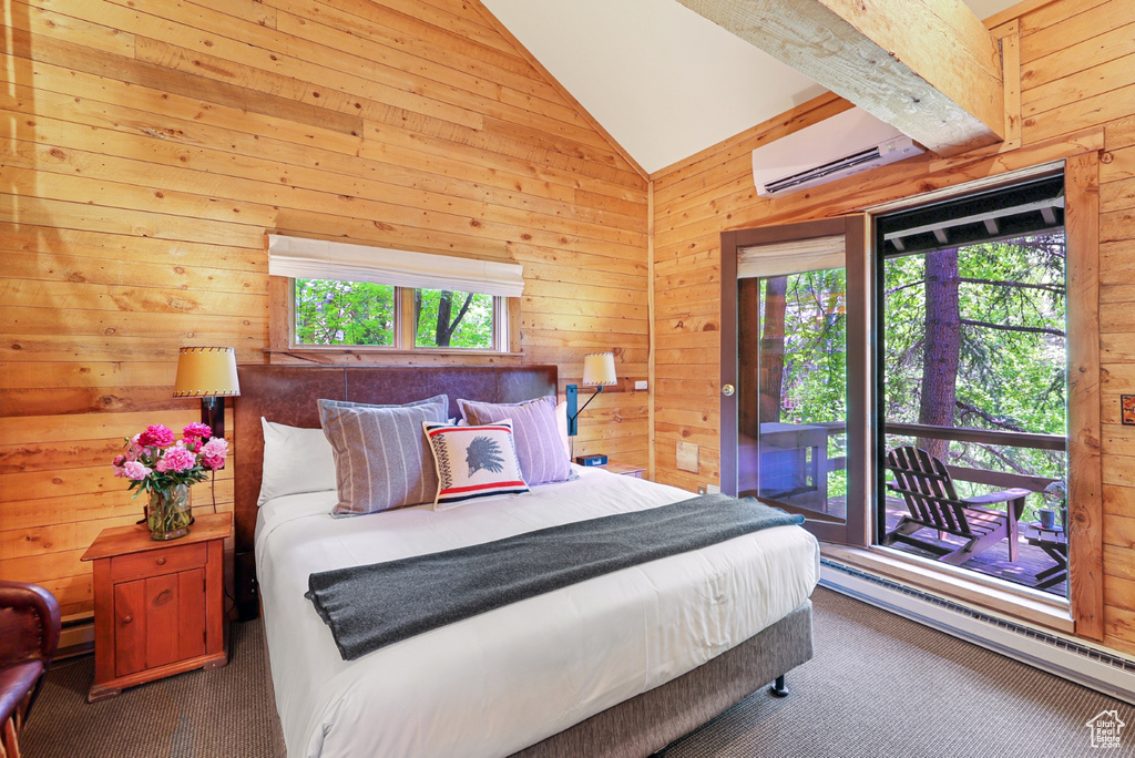 Carpeted bedroom with wooden walls, a wall mounted AC, lofted ceiling, access to exterior, and a baseboard radiator