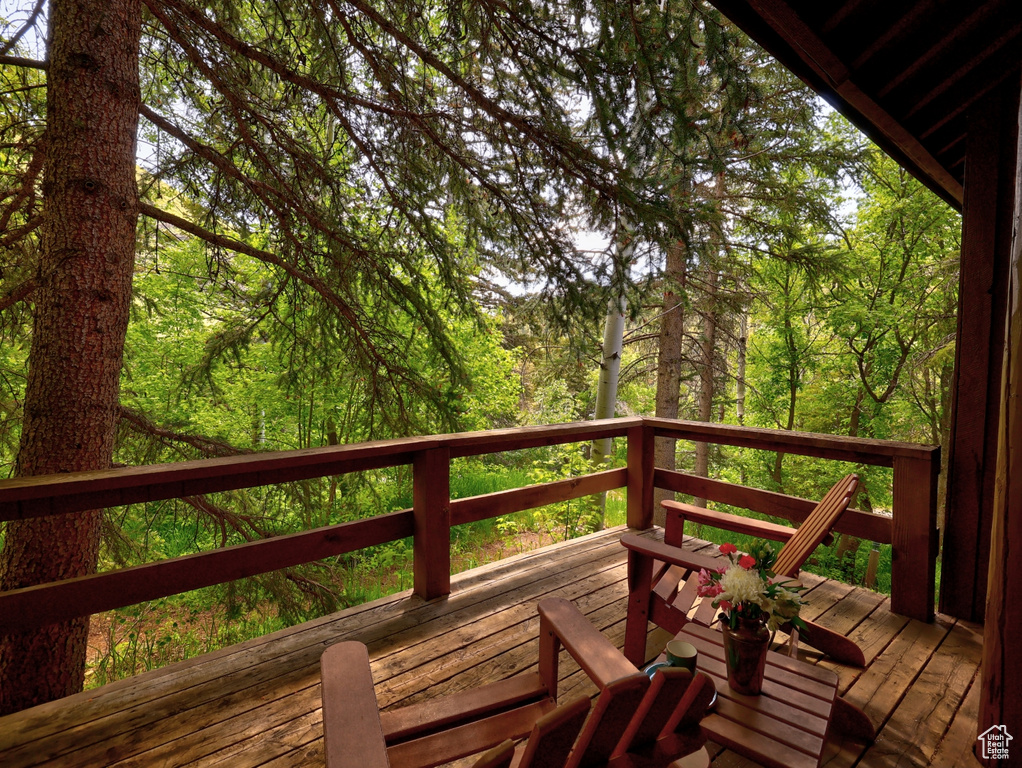 Wooden deck featuring a wooded view