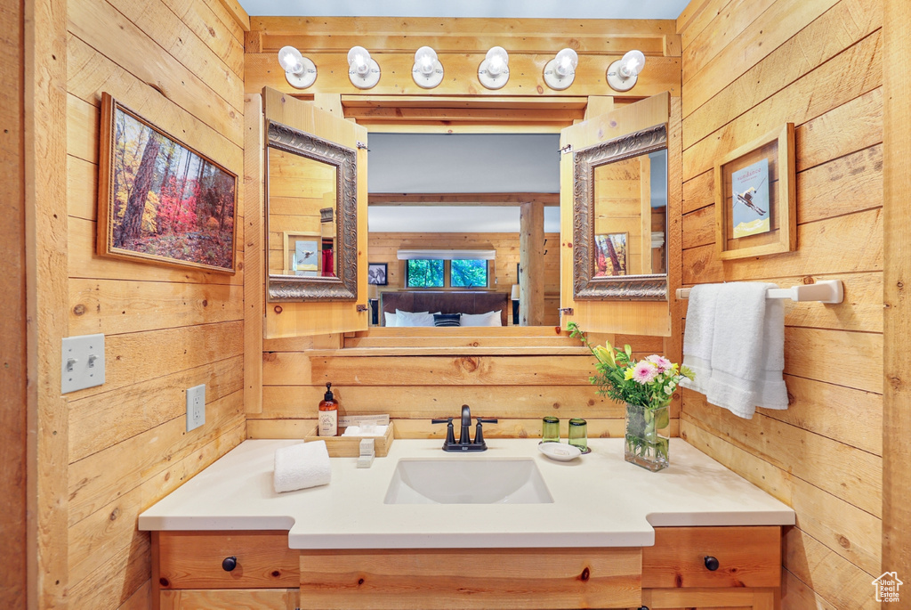 Bathroom with wood walls and vanity