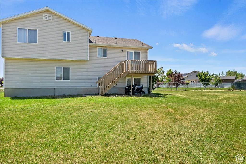 Back of property with stairway and a wooden deck