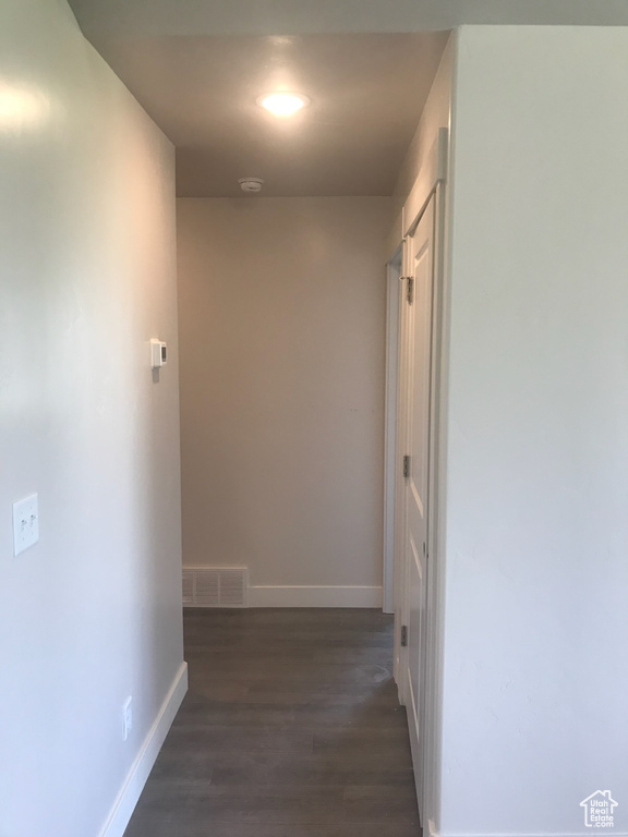 Hall with dark wood finished floors and baseboards