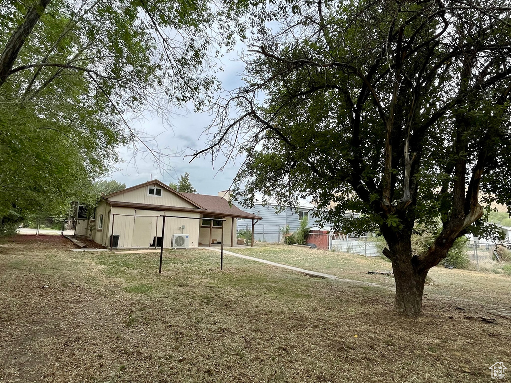 Rear view of house featuring ac unit