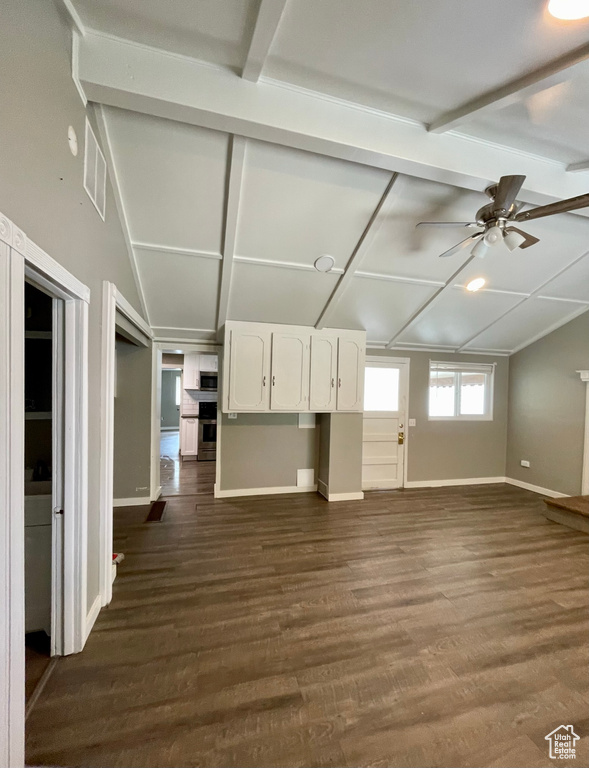 Unfurnished living room with baseboards, ceiling fan, and dark wood-style floors