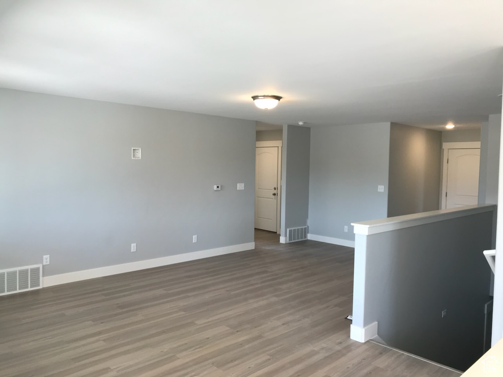 Spare room with baseboards and wood finished floors