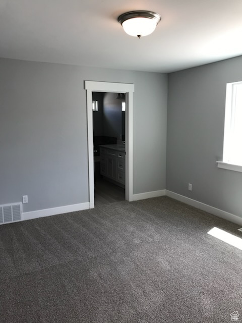 Spare room with carpet floors and baseboards
