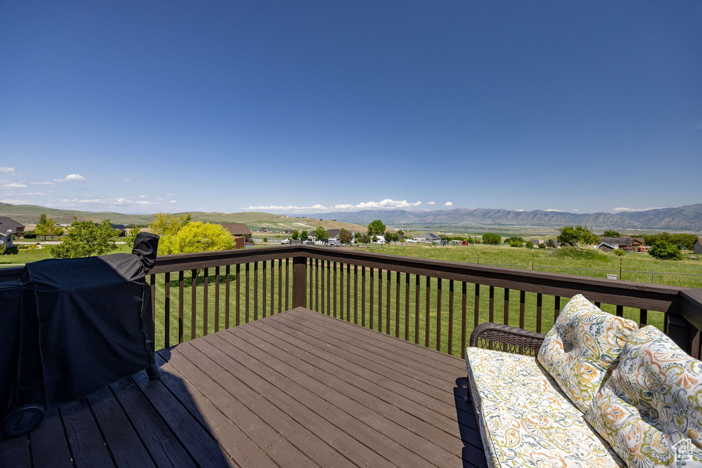 Wooden terrace with a mountain view and a lawn