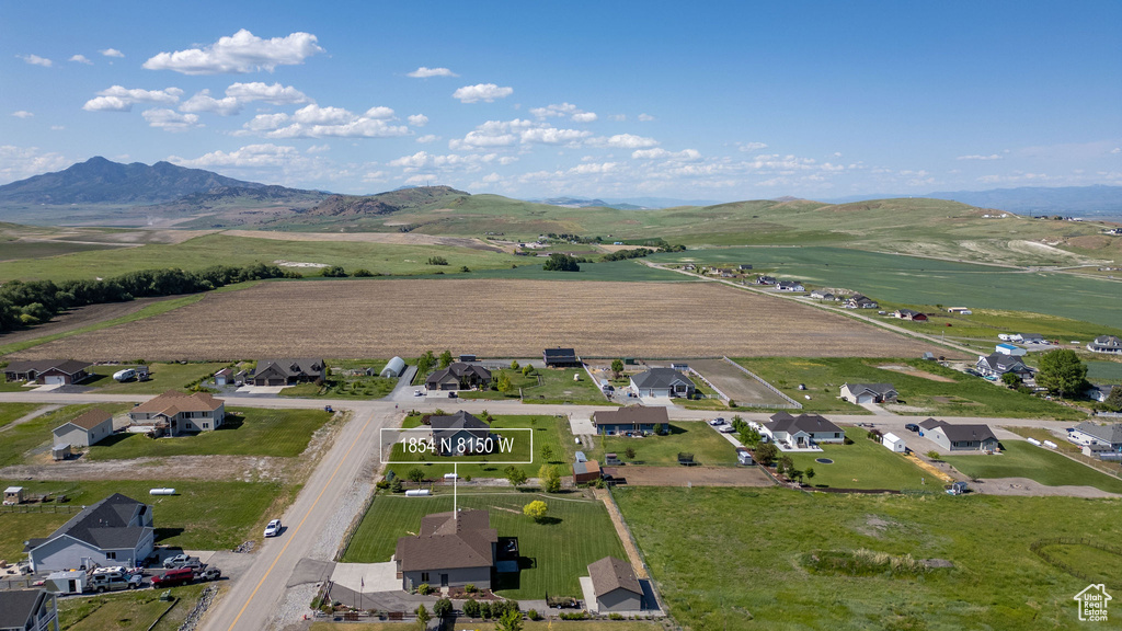 View of property location with a mountain backdrop and nearby suburban area