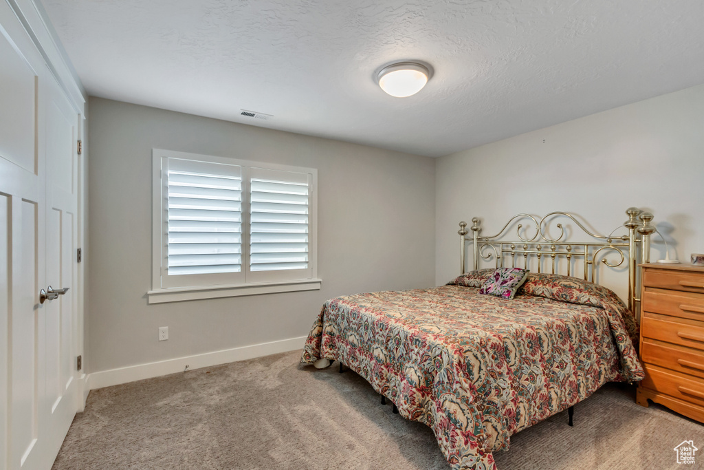 Bedroom with carpet and baseboards