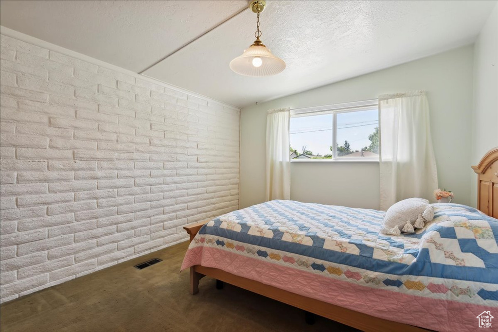 Bedroom featuring carpet flooring and lofted ceiling
