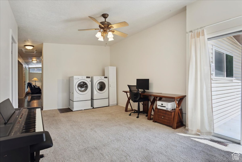 Laundry room featuring washer and dryer, an office area, carpet flooring, ceiling fan, and healthy amount of natural light