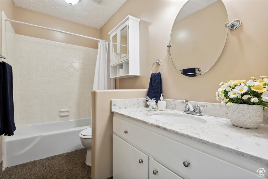 Full bathroom with vanity, toilet, and shower / bath combo