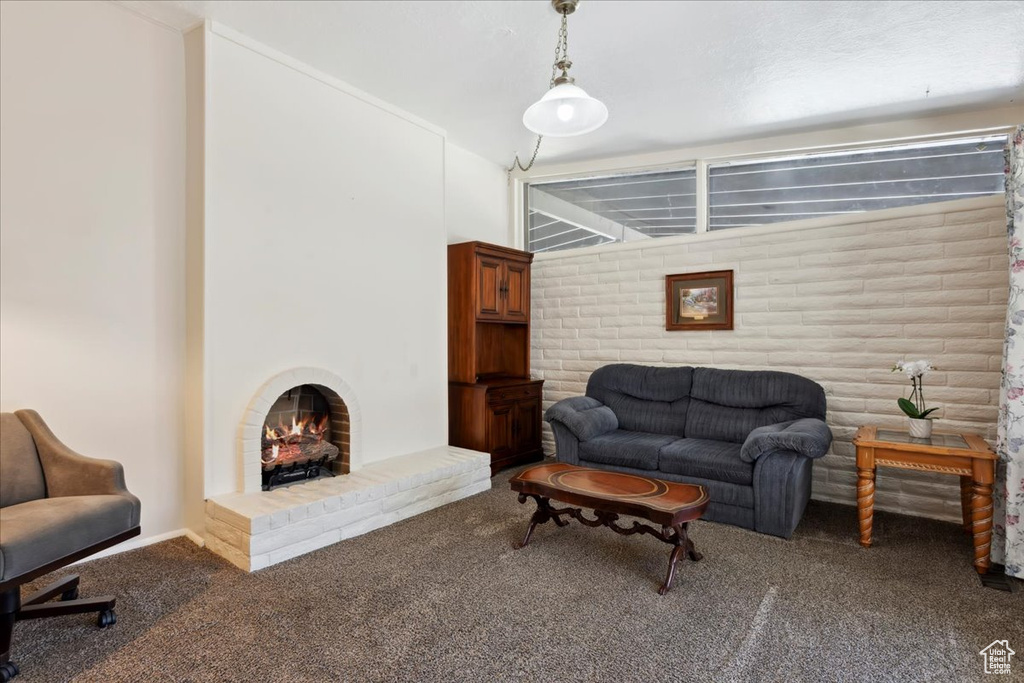 Carpeted living room with a fireplace and baseboards