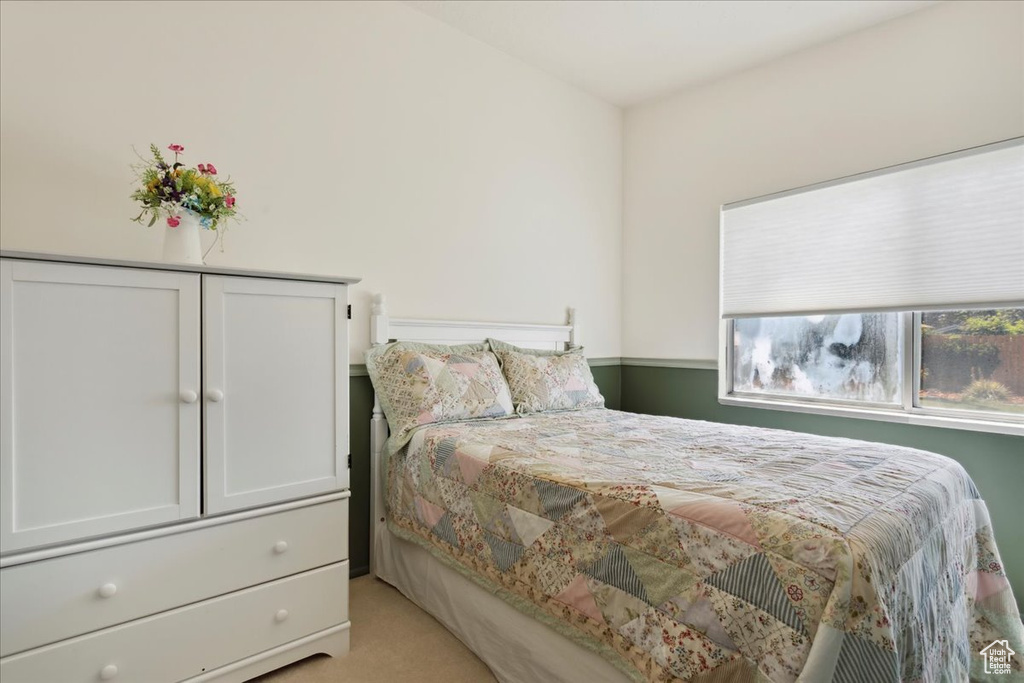 Bedroom featuring light colored carpet