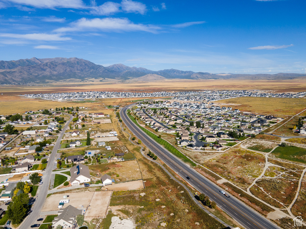 Aerial view of property\'s location with a mountainous background and nearby suburban area
