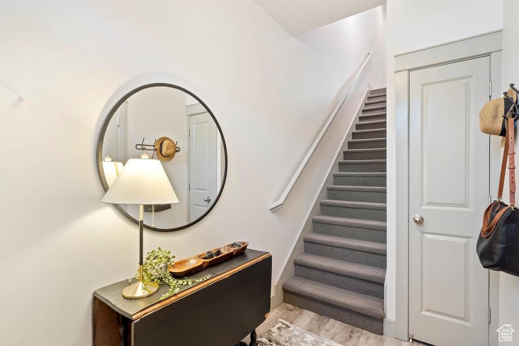 Stairway featuring wood finished floors
