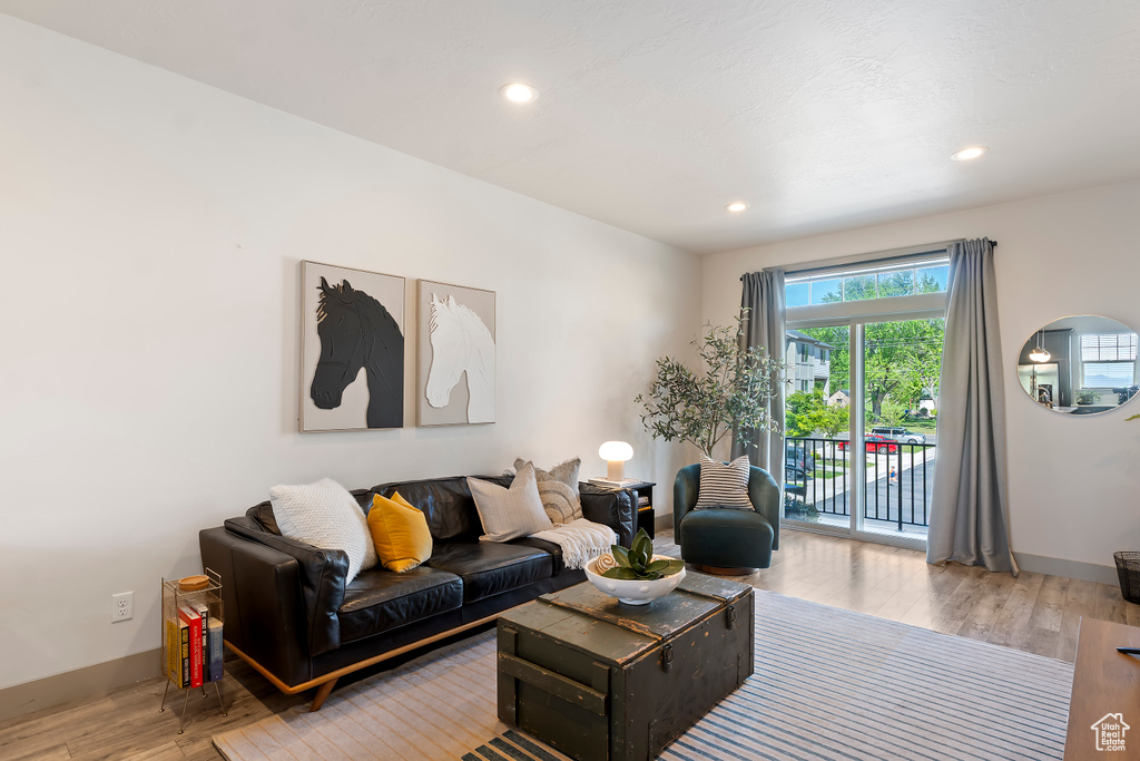 Living room featuring wood finished floors, baseboards, and recessed lighting