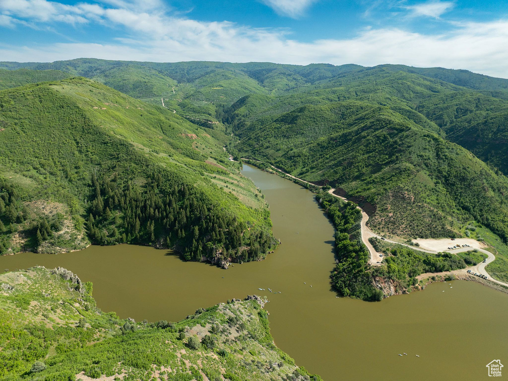 Aerial view of property and surrounding area with a water and mountain view