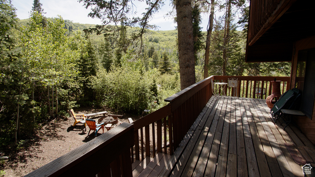 Wooden terrace featuring a forest view