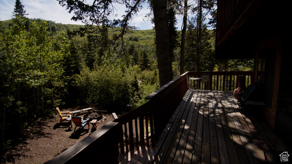 Wooden deck featuring a wooded view
