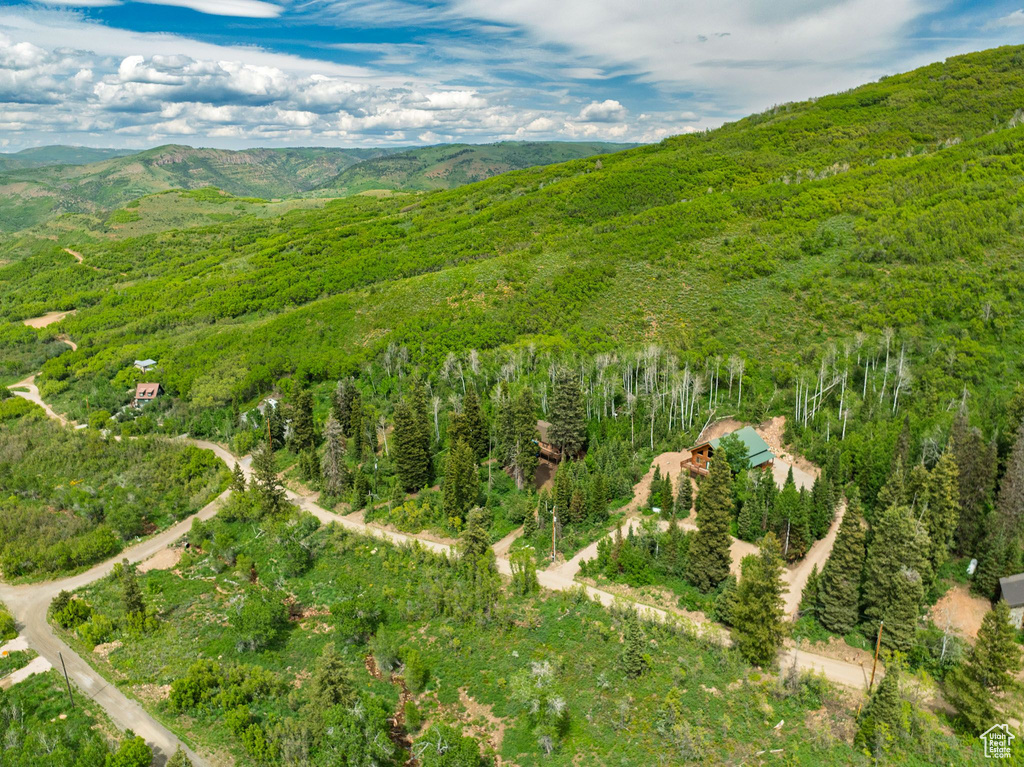 Aerial view of property's location featuring a mountainous background