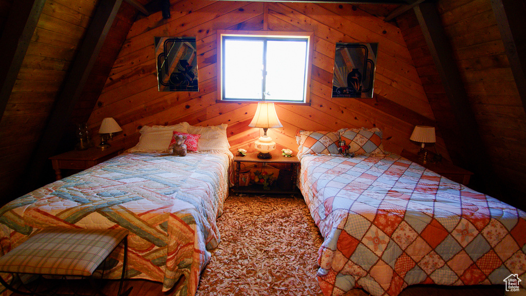 Bedroom featuring wood walls, carpet floors, and lofted ceiling