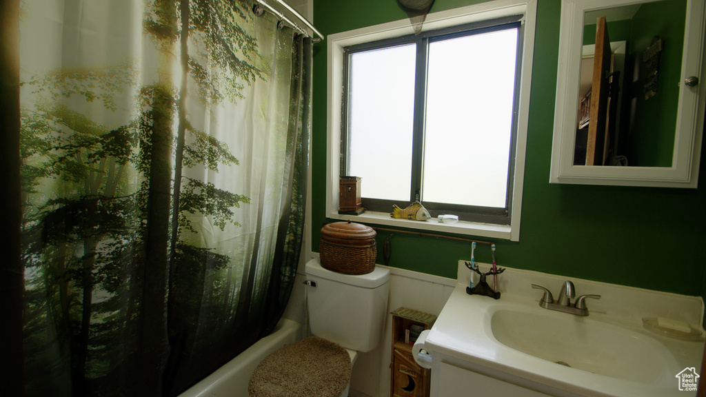 Full bath featuring vanity, toilet, and shower / bath combo
