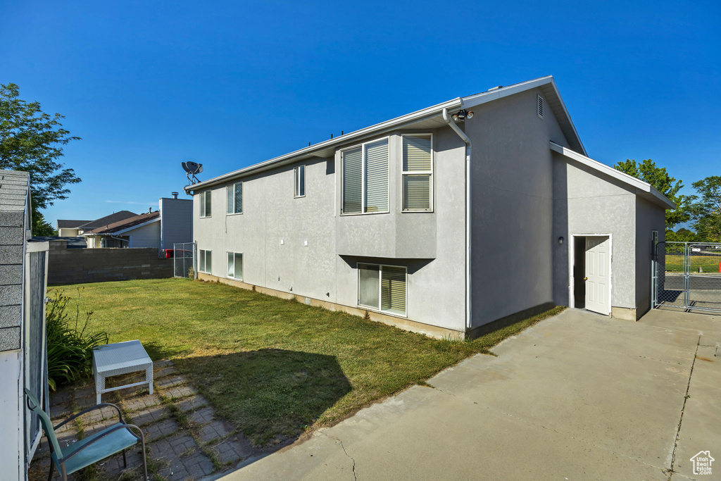 Back of property with a patio area, stucco siding, and a gate