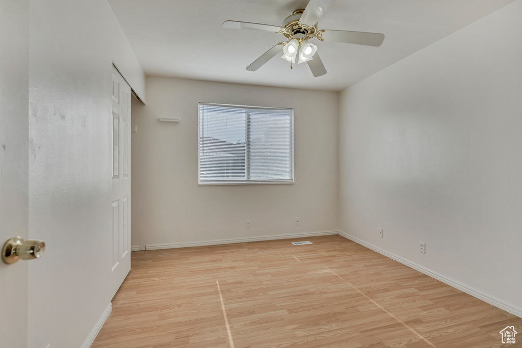 Unfurnished bedroom featuring light wood finished floors and baseboards