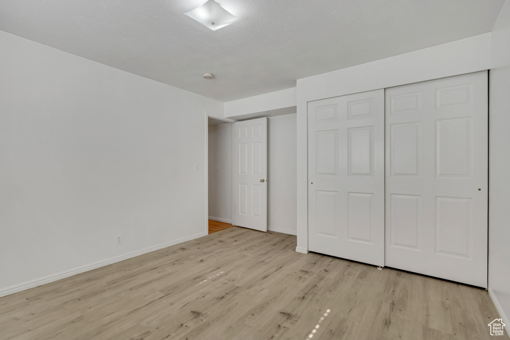 Unfurnished bedroom with light wood-type flooring and baseboards