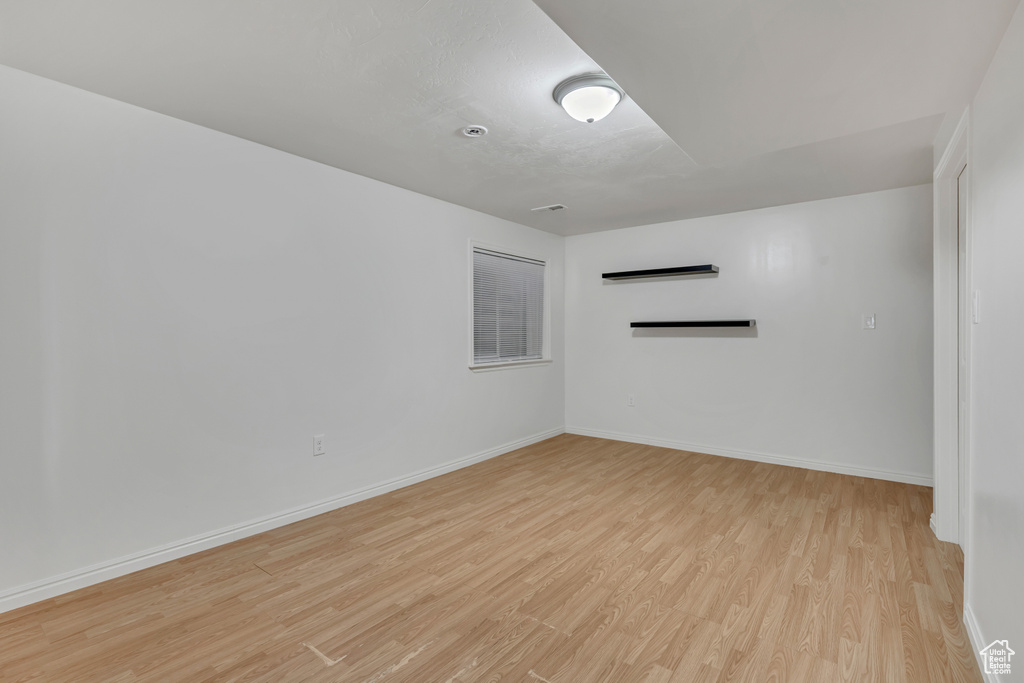 Spare room with light wood-style flooring and baseboards